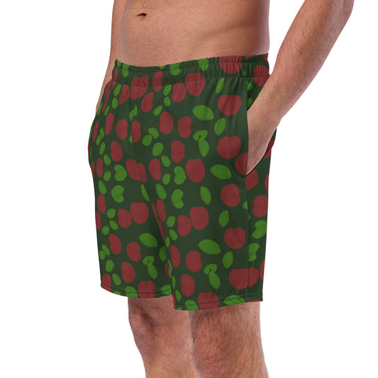 left front view of model wearing cherry swim trunks in forest green