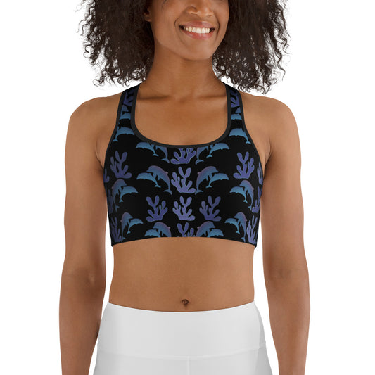 front view of model wearing coral reef dolphins sports bra in black