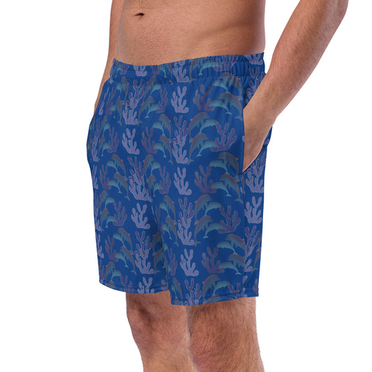 left front view of model wearing coral reef dolphins swim trunks in bright blue