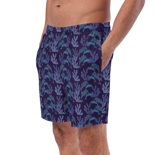 left front view of model wearing coral reef dolphins swim trunks in purple