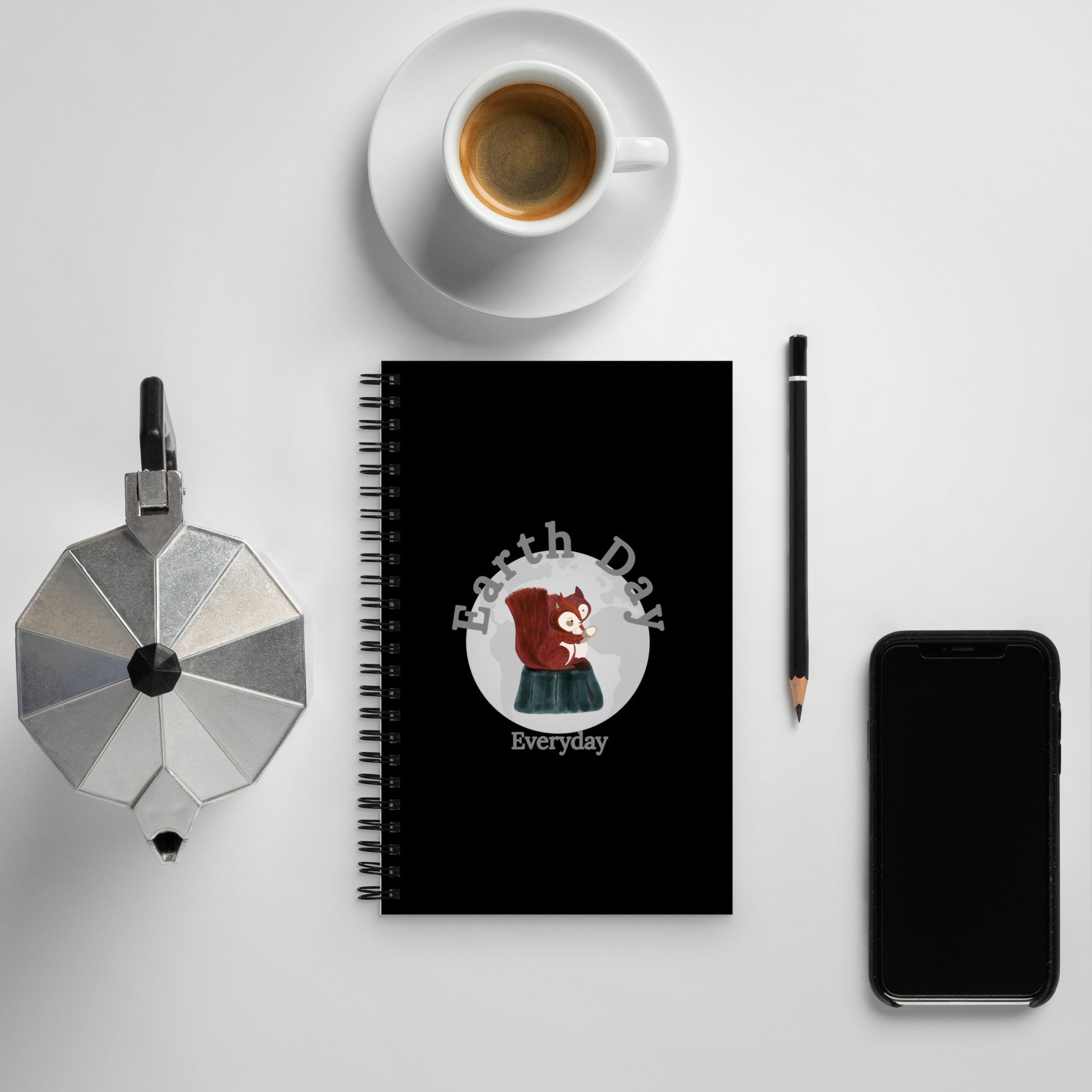 Earth Day Everyday Squirrels Spiral Notebook with black cover featuring a squirrel illustration next to coffee cup and smartphone