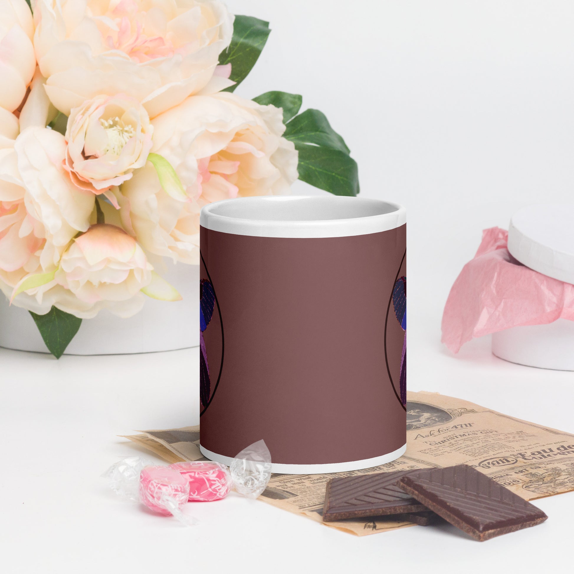 White ceramic mug with an enchanted butterfly with a dark ring on dark background 