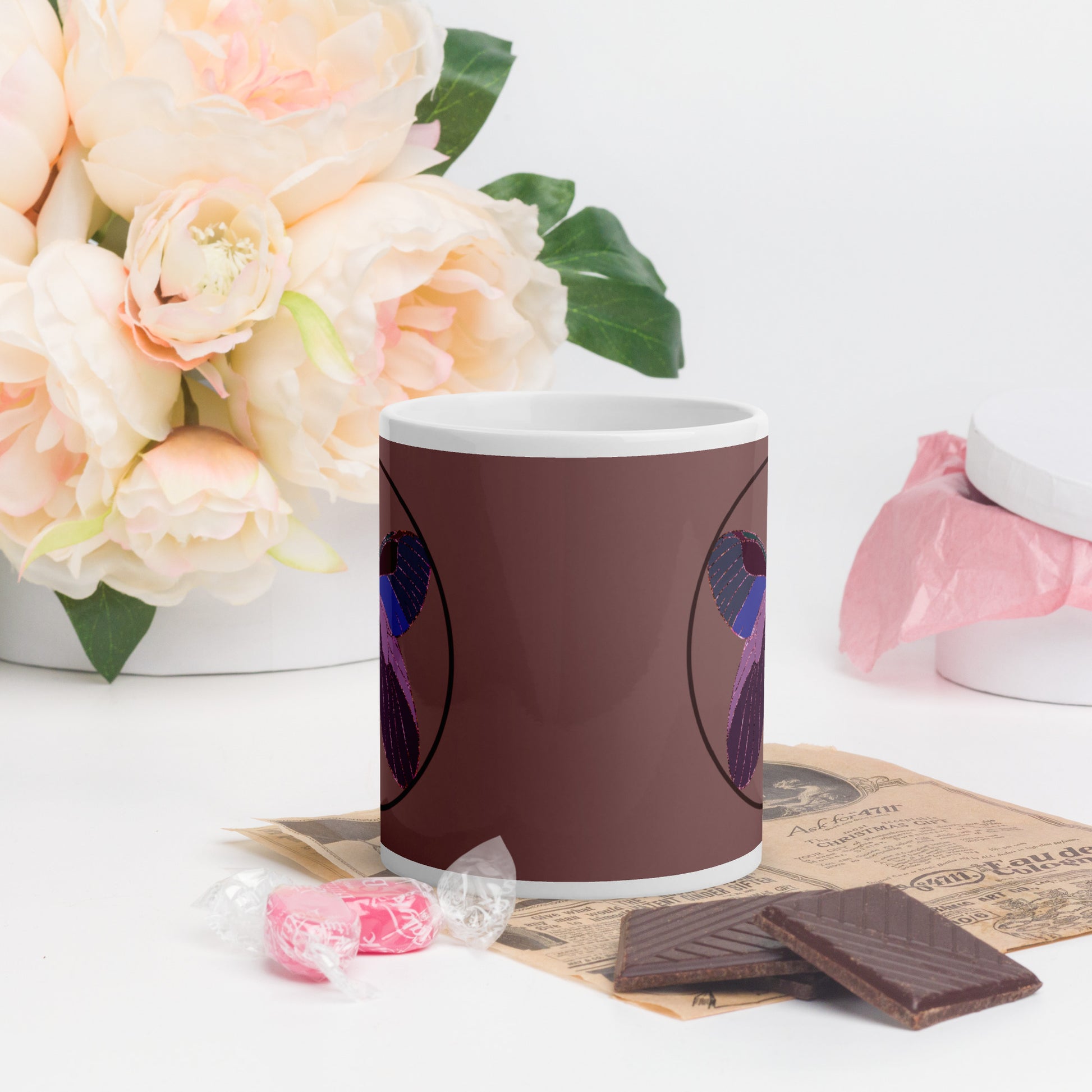 White ceramic mug with an enchanted butterfly with a dark ring on dark background 