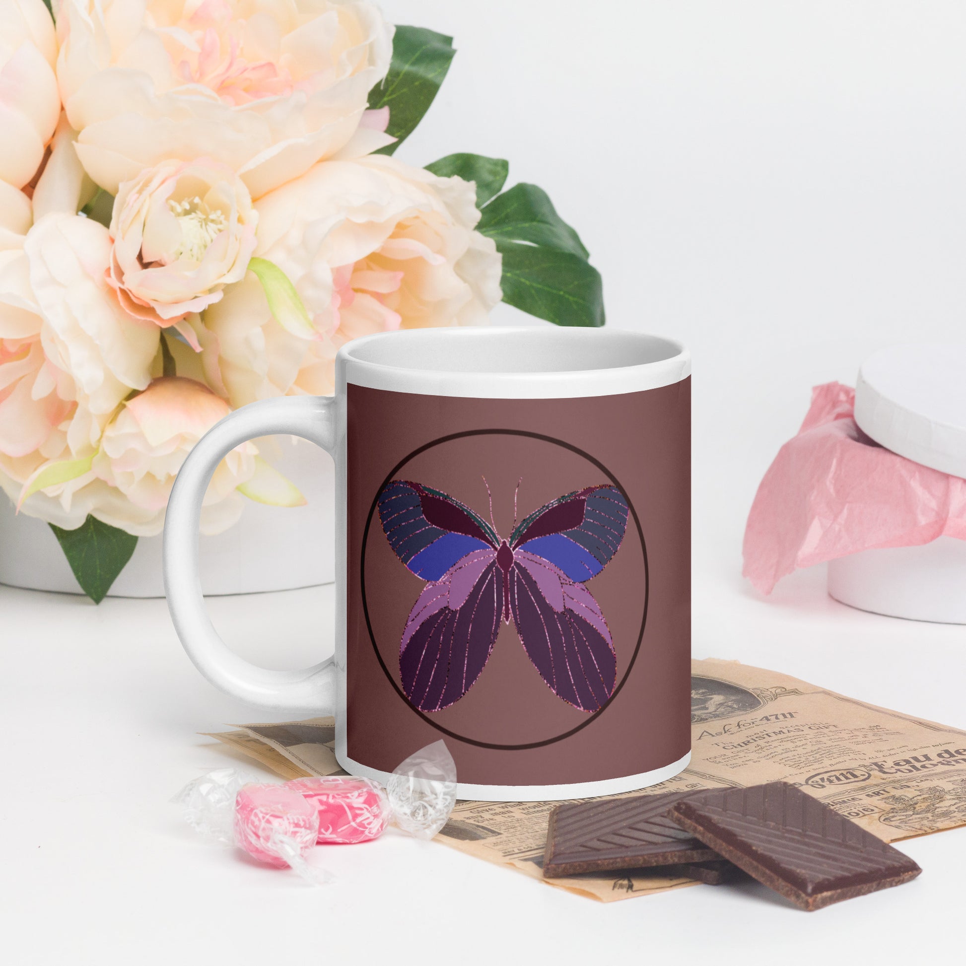 White ceramic mug with an enchanted butterfly with a dark ring on dark background 