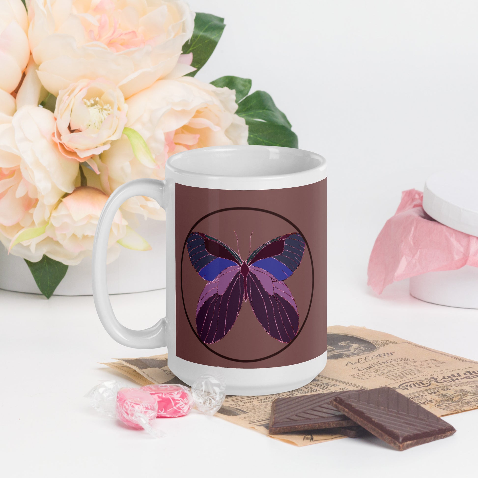 White ceramic mug with an enchanted butterfly with a dark ring on dark background 