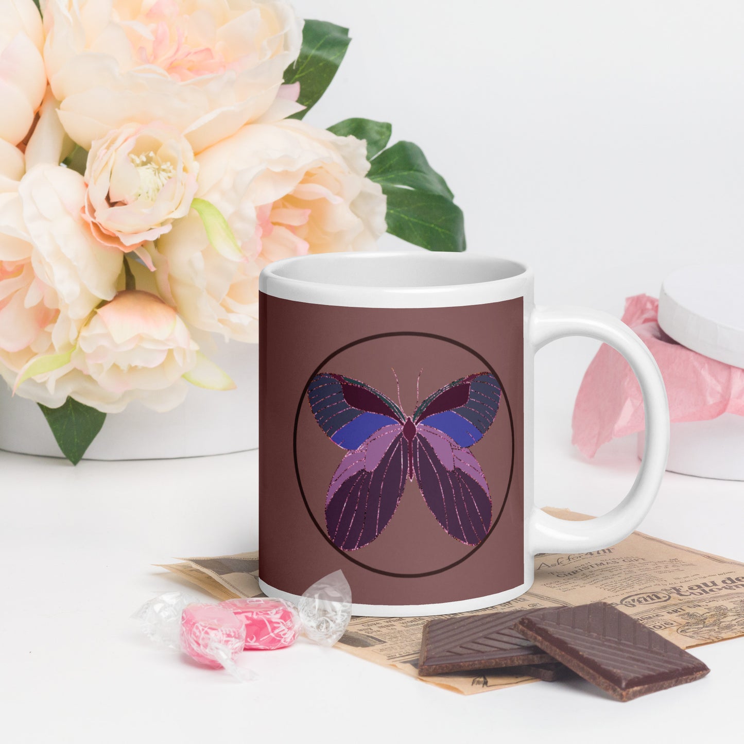 White ceramic mug with an enchanted butterfly with a dark ring on dark background 