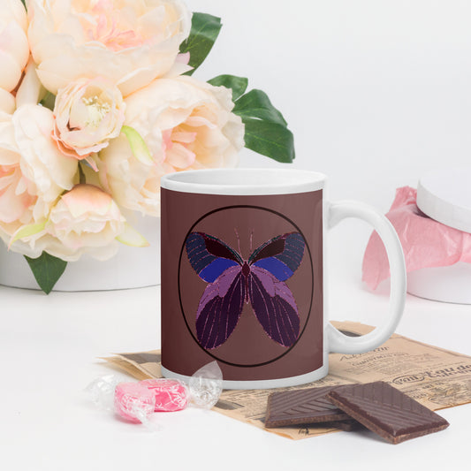 White ceramic mug with an enchanted butterfly with a dark ring on dark background 