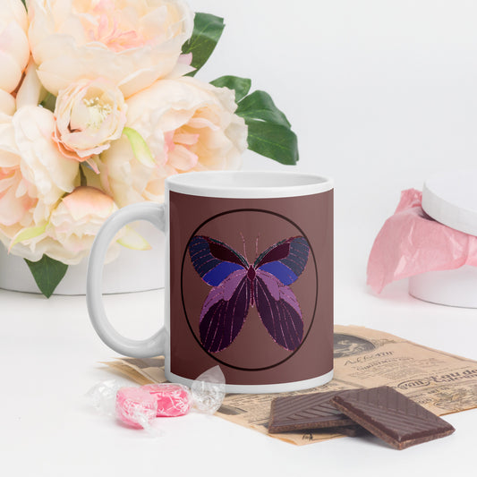White ceramic mug with an enchanted butterfly with a dark ring on dark background. Perfect gift for earth day, housewarmings, birthdays, Valentines, Thanksgiving, Christmas, Father’s Day and Mother’s Day. 